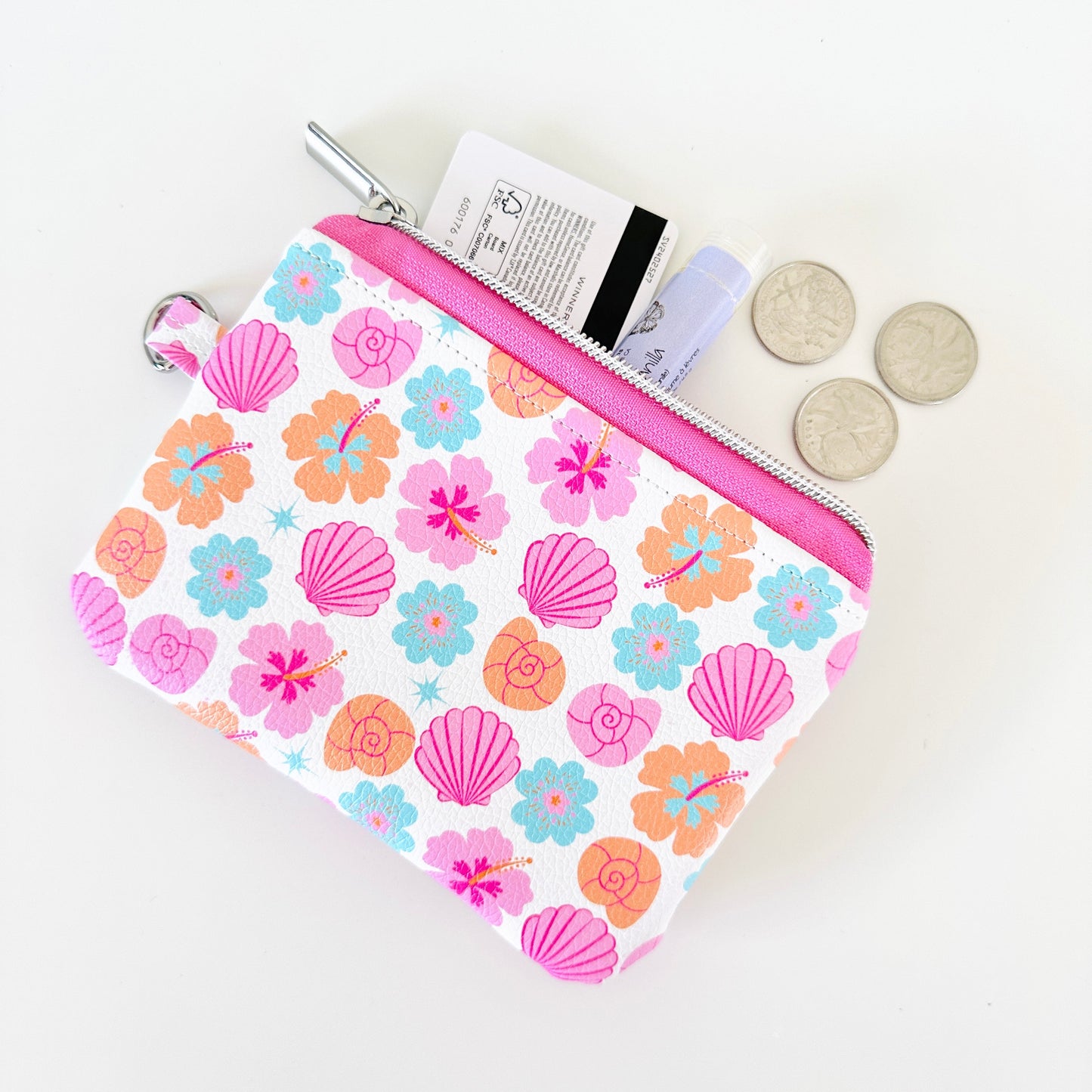 sea shell vegan leather coin purse with seashell pattern on a white background