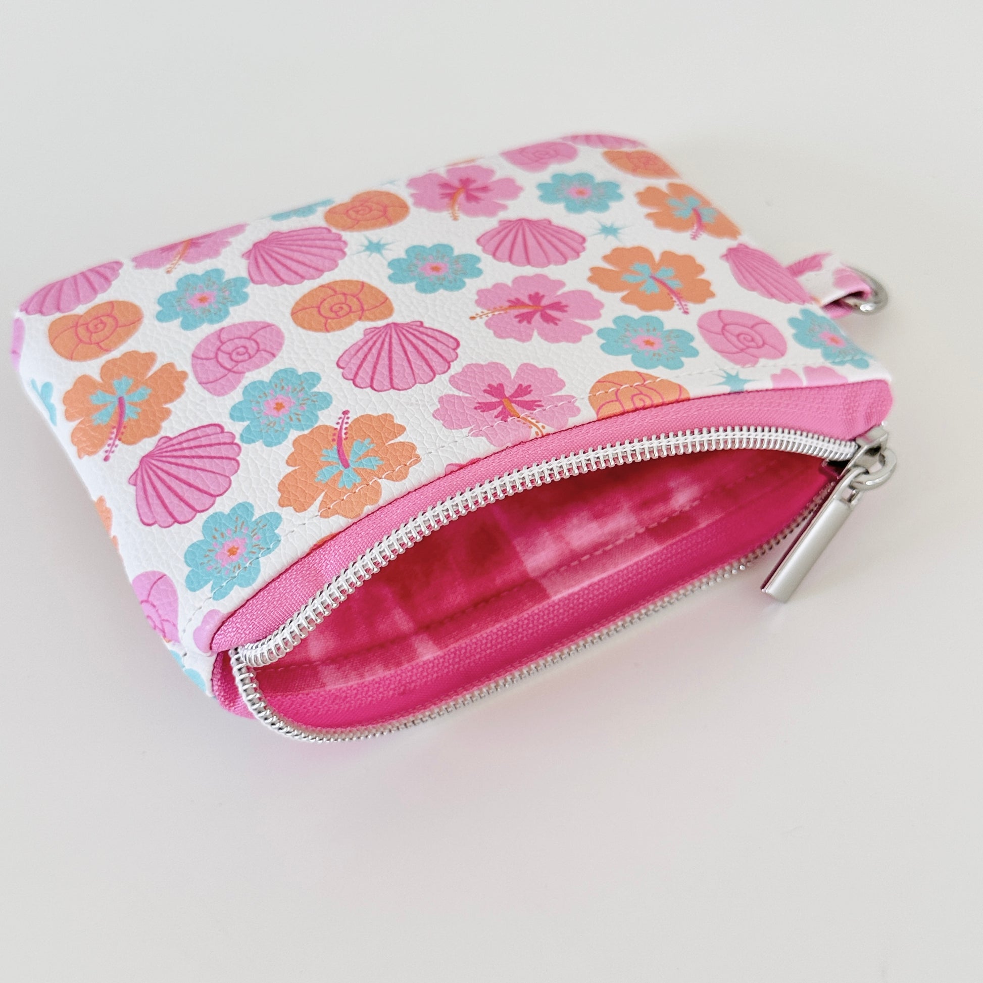 sea shell vegan leather coin purse with seashell pattern on a white background