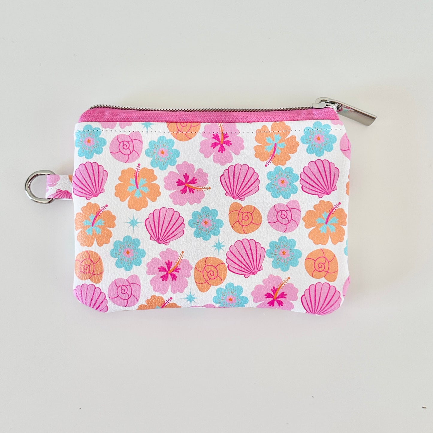 sea shell vegan leather coin purse with seashell pattern on a white background