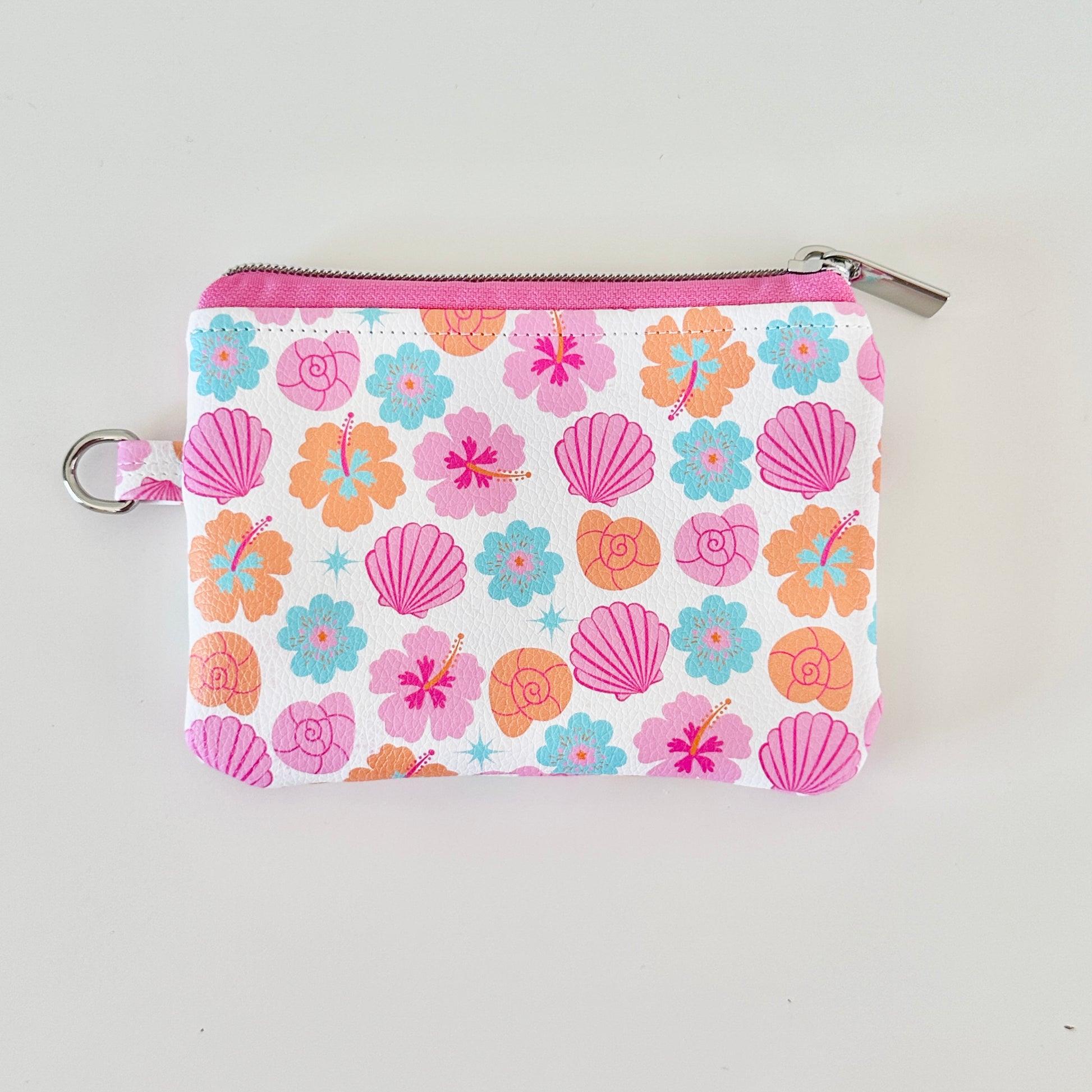 sea shell vegan leather coin purse with seashell pattern on a white background