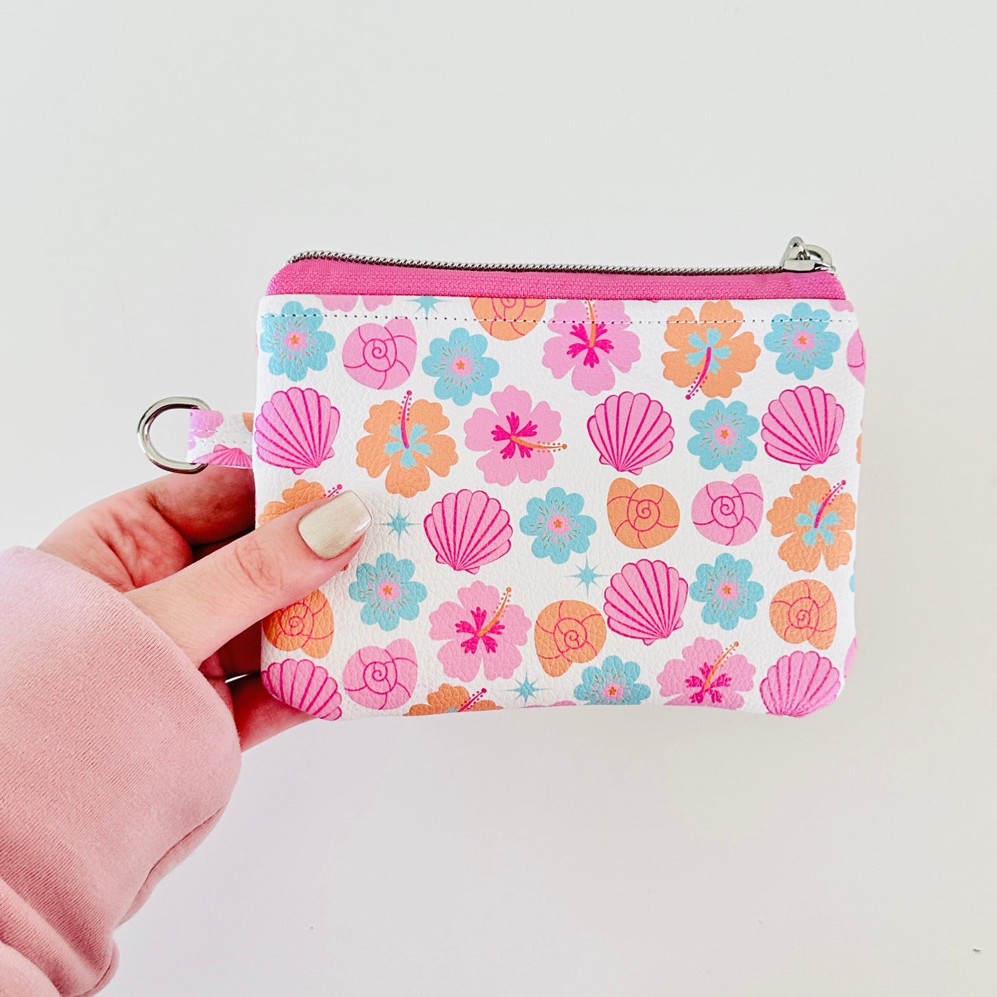 sea shell vegan leather coin purse with seashell pattern on a white background