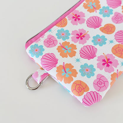 sea shell vegan leather coin purse with seashell pattern on a white background