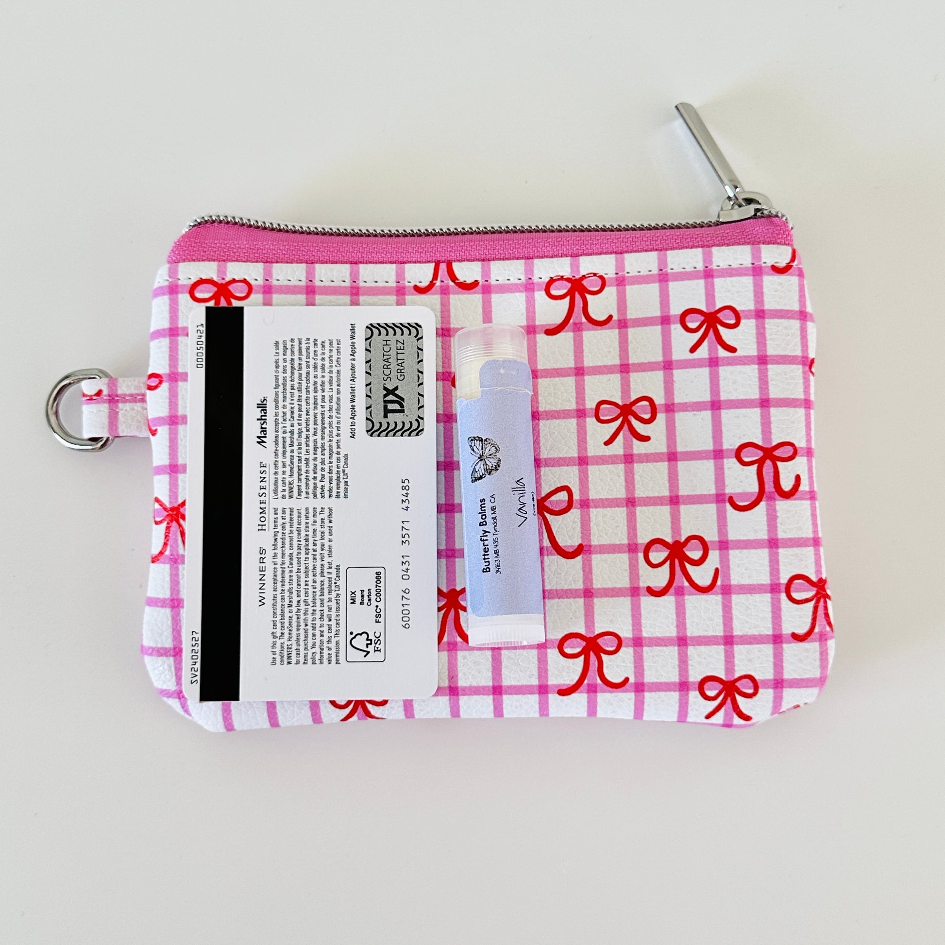 Pink checkered coquette vegan leather coin purse with red bows on a white background