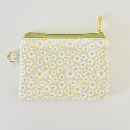 green daisy Floral-patterned coin purse  with coins and cards on a light background