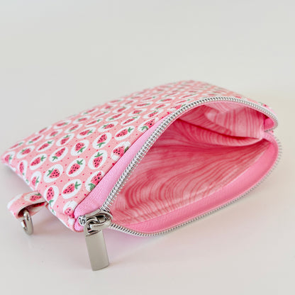 Pink strawberry coin purse on a white background