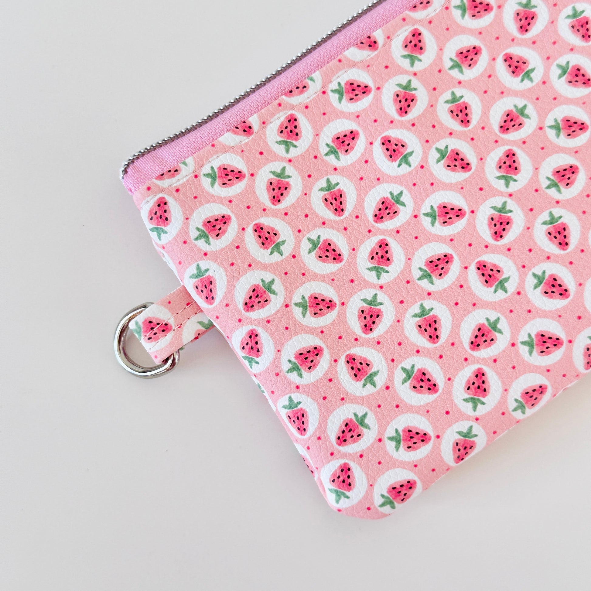 Pink strawberry coin purse on a white background