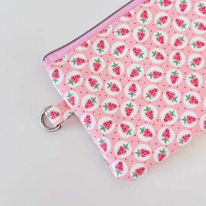 Pink strawberry coin purse on a white background