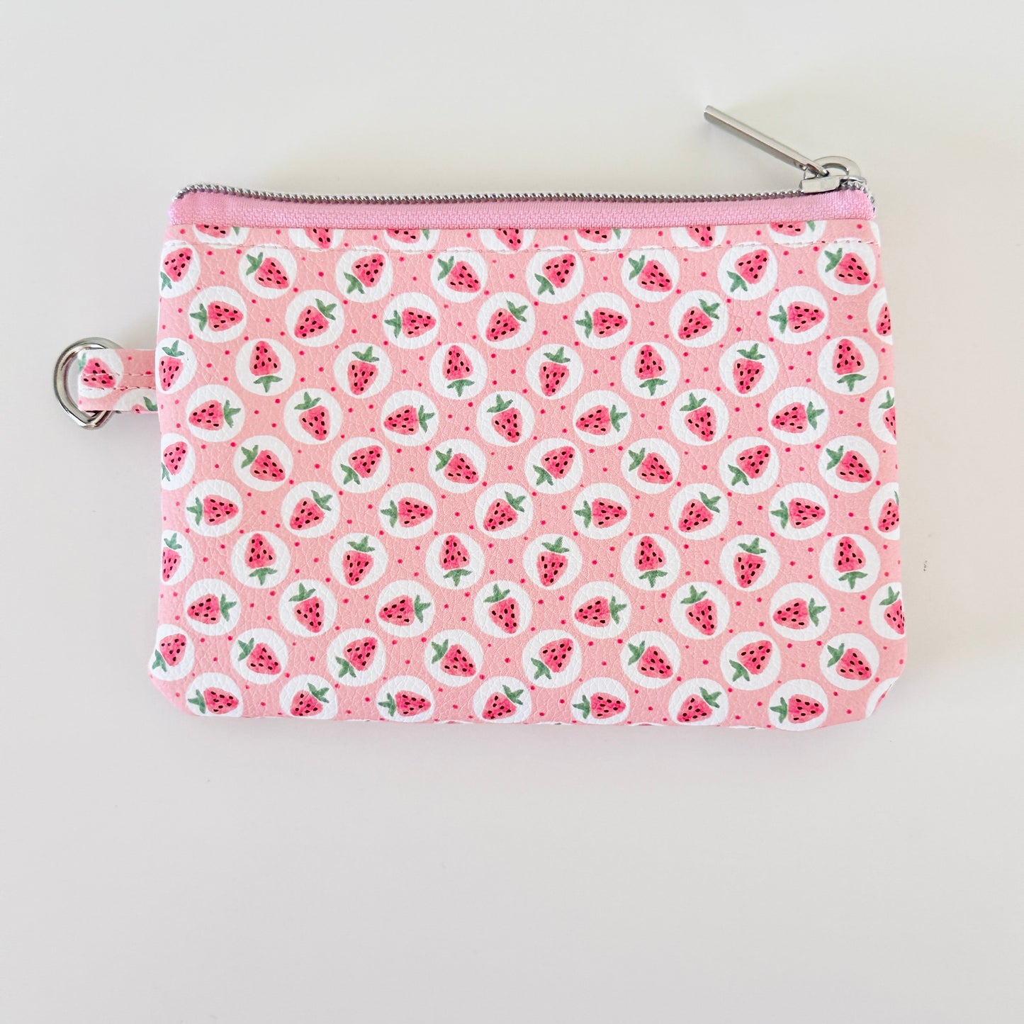Pink strawberry coin purse on a white background