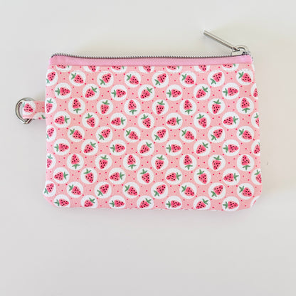 Pink strawberry coin purse on a white background