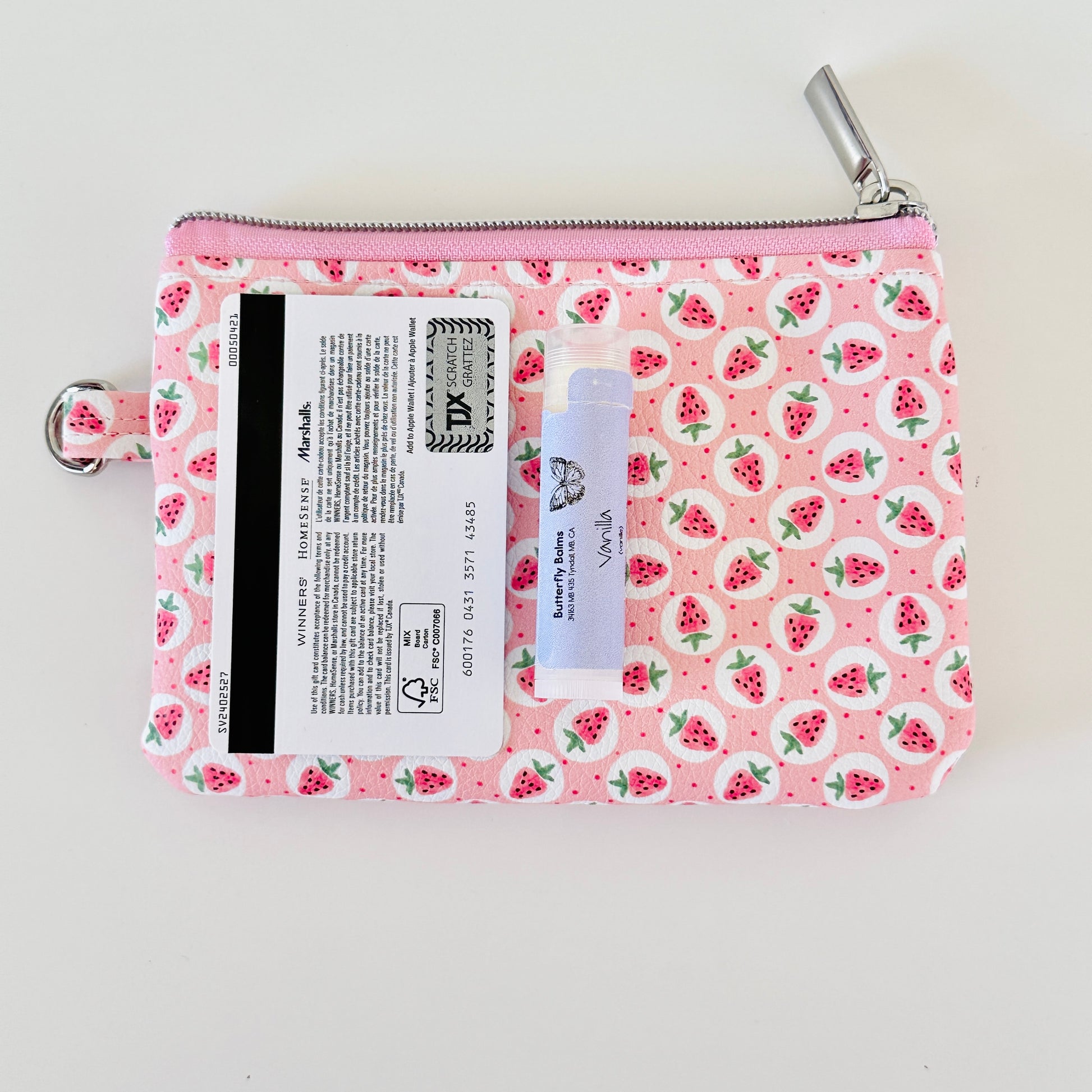 Pink strawberry coin purse on a white background