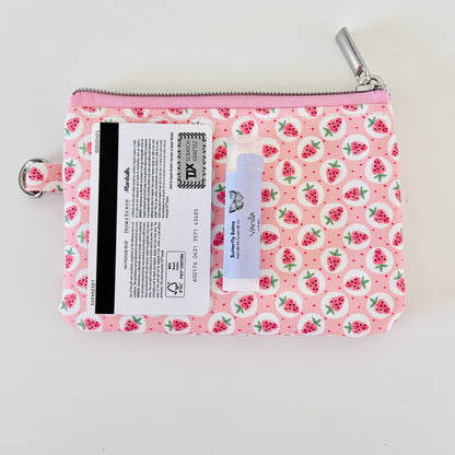 Pink strawberry coin purse on a white background