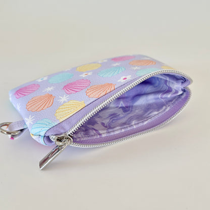 purple vegan leather coin purse with seashell pattern on a white background