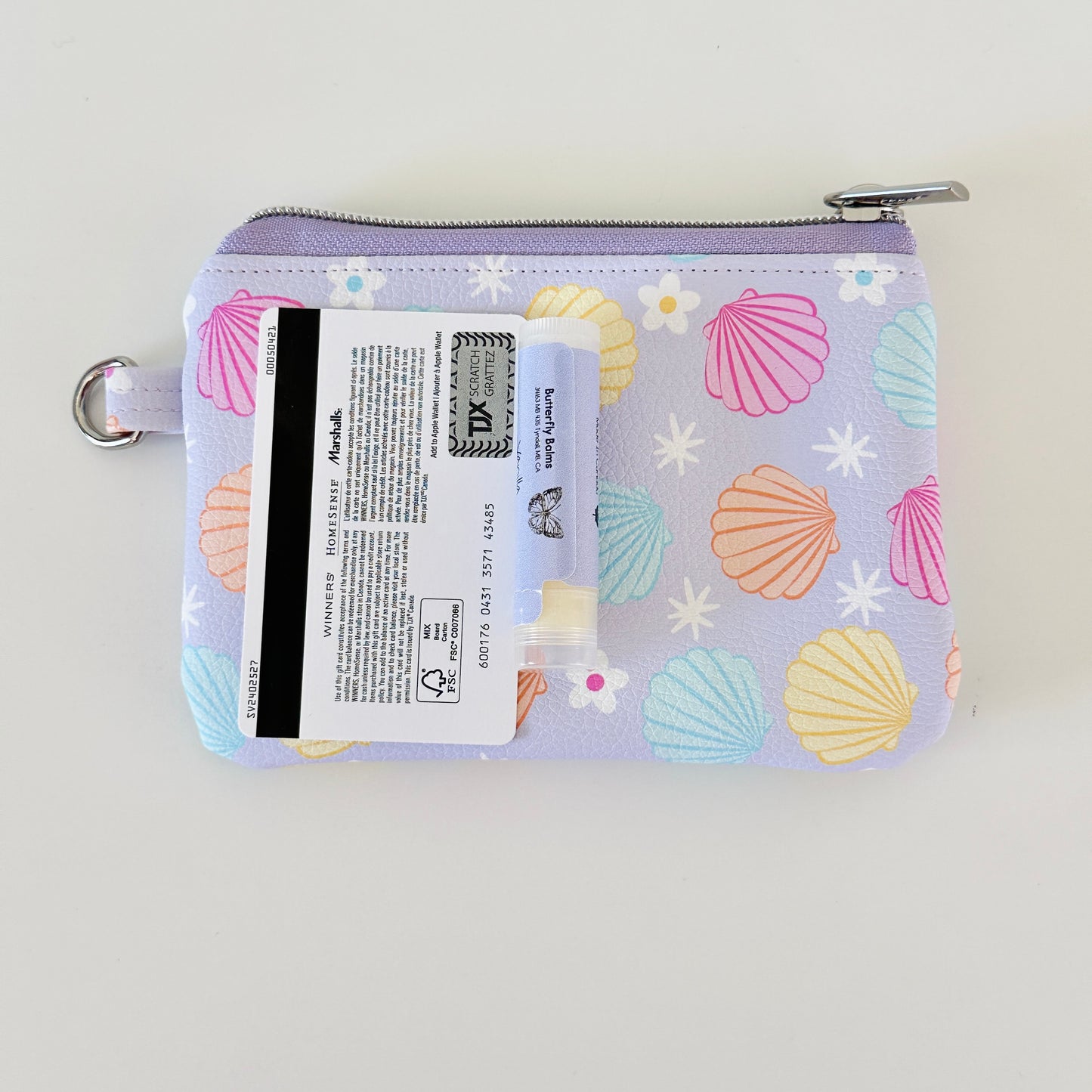 purple vegan leather coin purse with seashell pattern on a white background