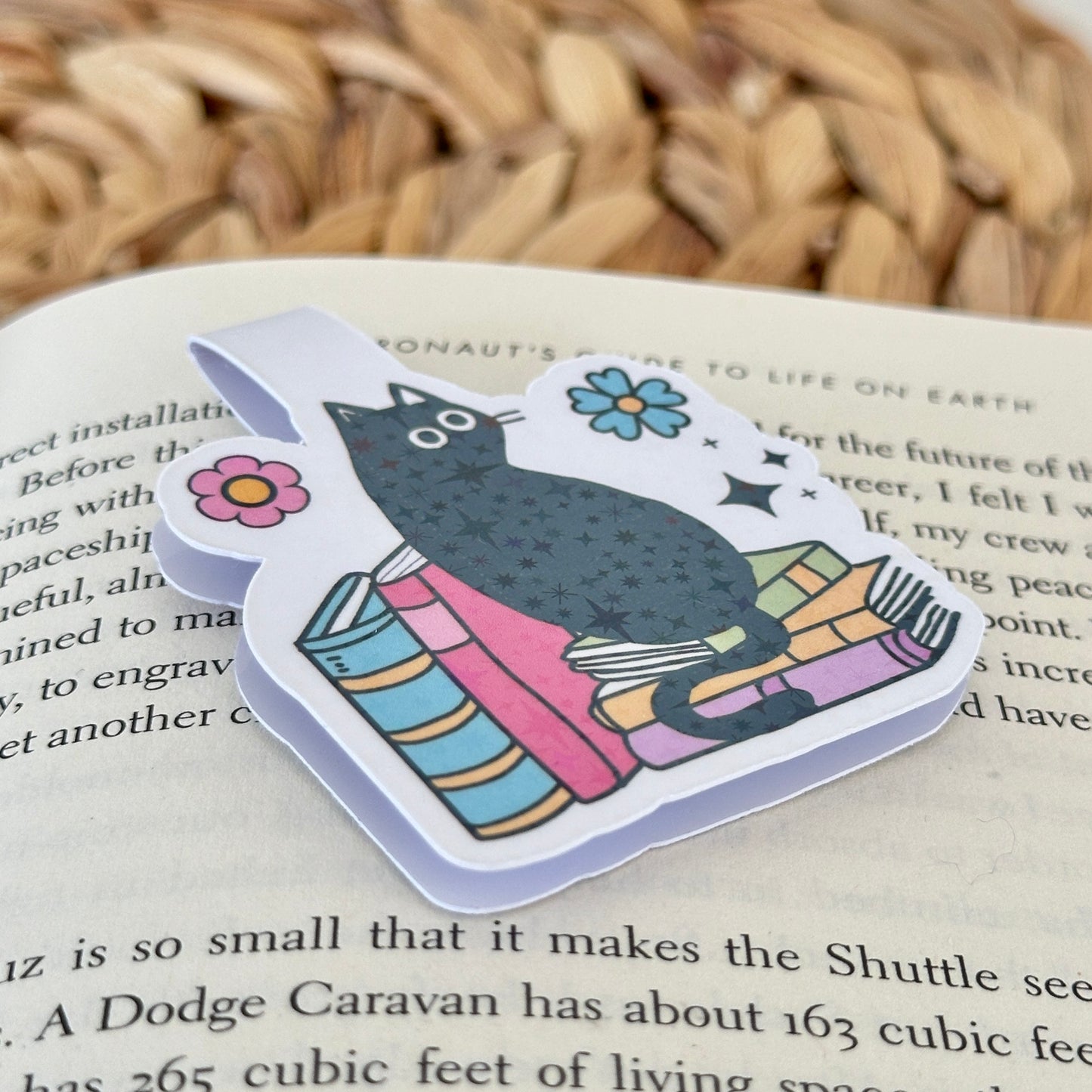 Magnetic bookmark with a black cat design on a gray textured background