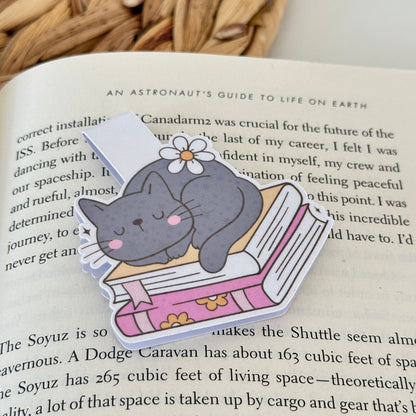Bookmark with a cat illustration on an open book
