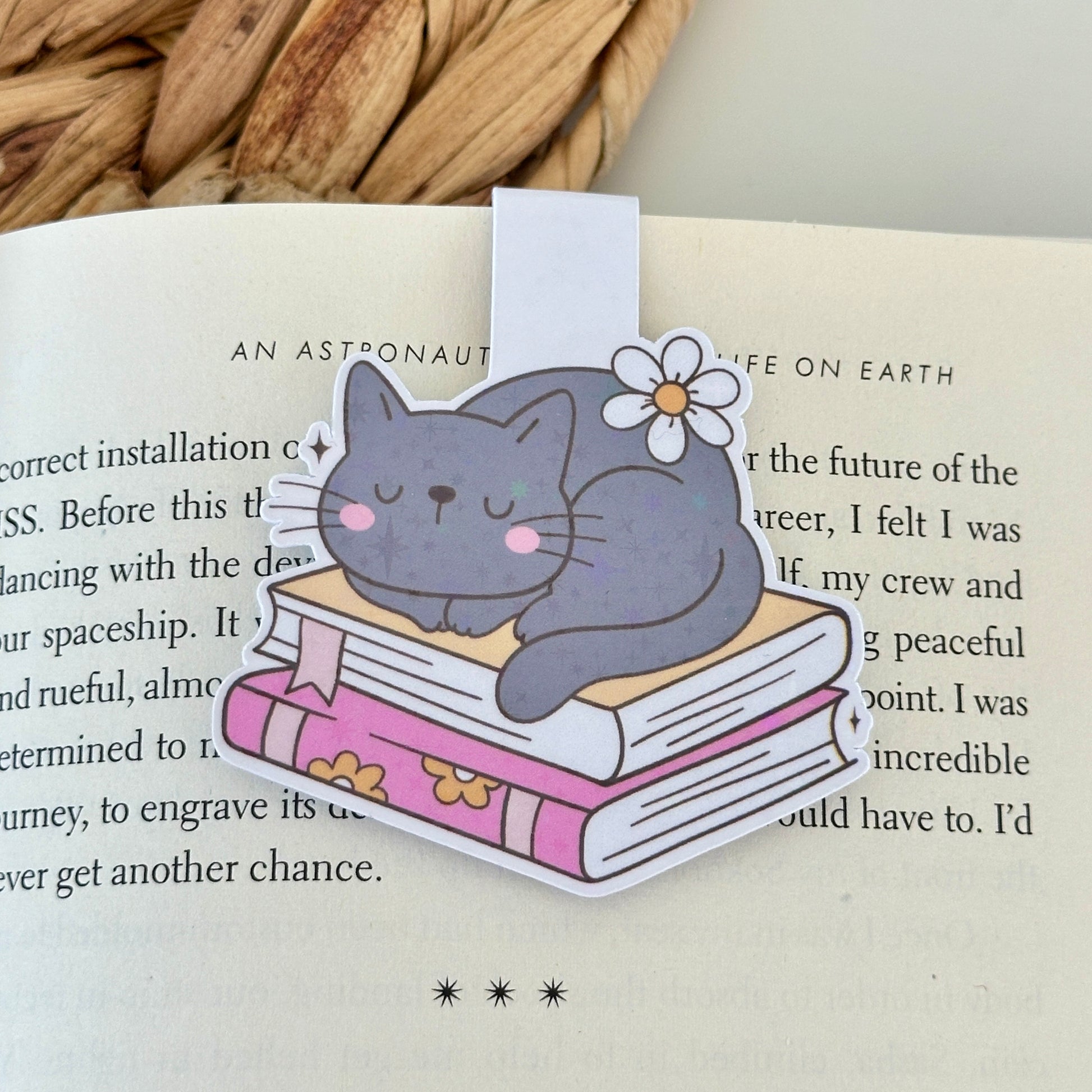 Bookmark with a cat illustration on an open book