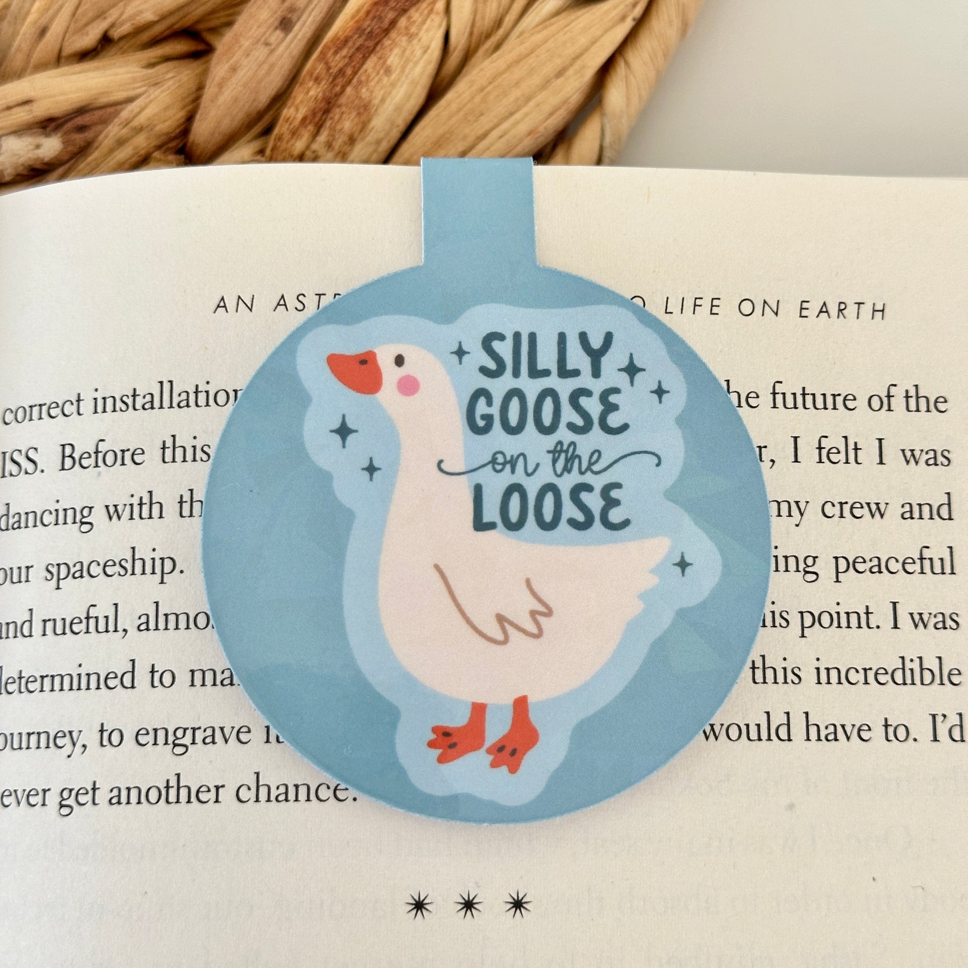 Bookmark with a cartoon goose and text 'Silly Goose on the Loose' on an open book.