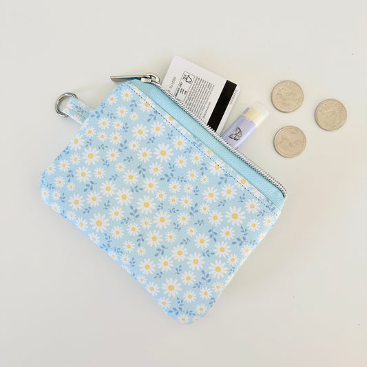 blue daisy Floral-patterned coin purse  with coins and cards on a light background