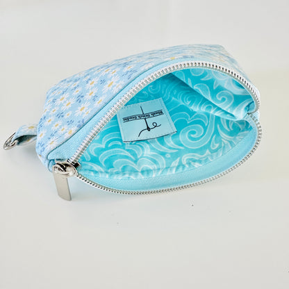 blue daisy Floral-patterned coin purse  with coins and cards on a light background