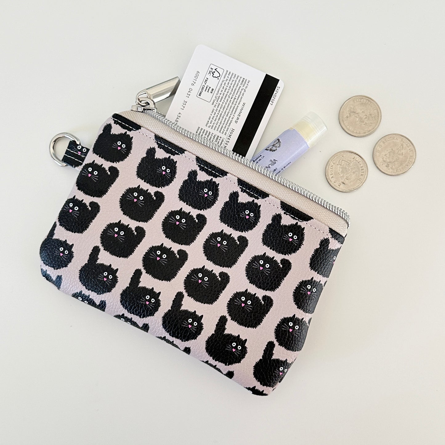 coin purse with a black cat pattern on a light background