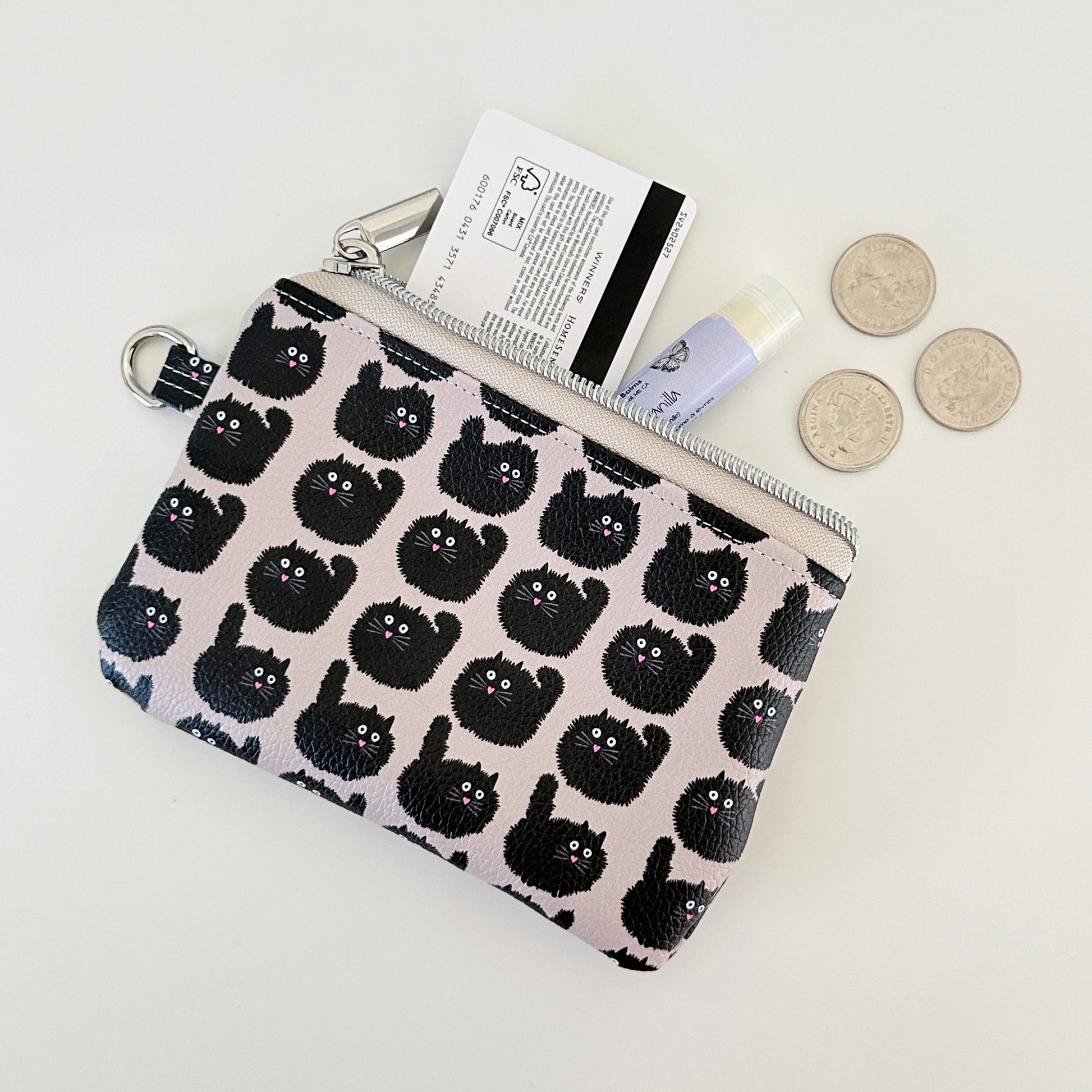 coin purse with a black cat pattern on a light background