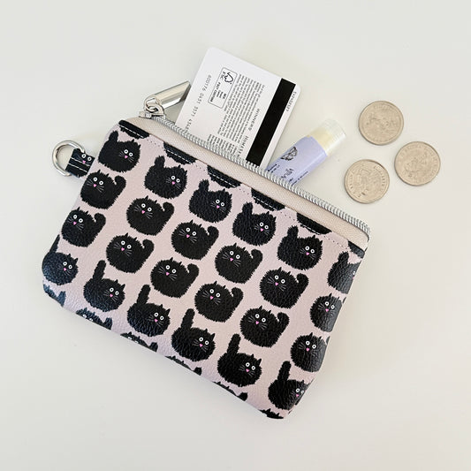 coin purse with a black cat pattern on a light background