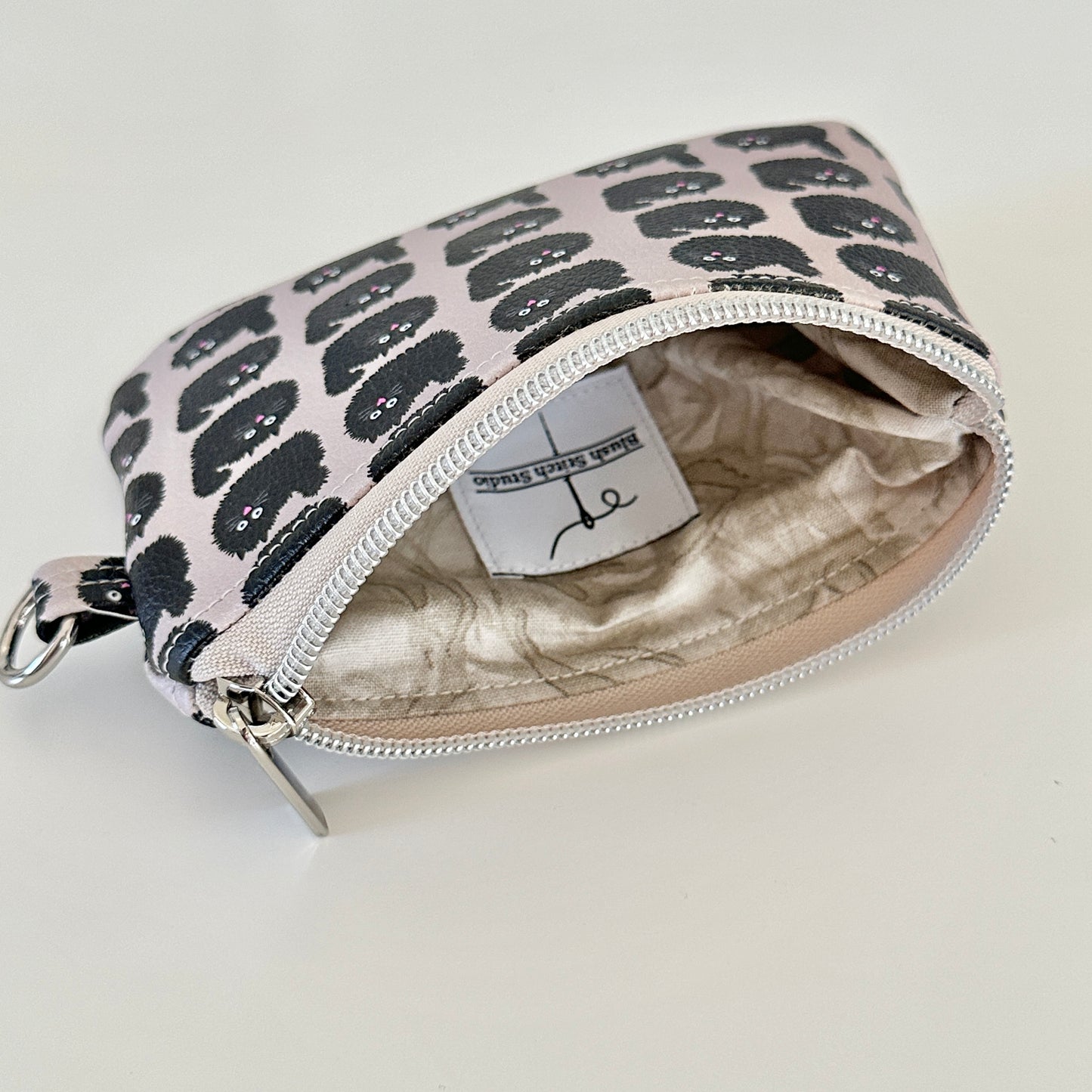 coin purse with a black cat pattern on a light background