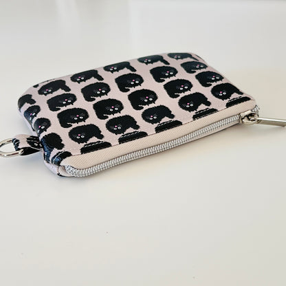coin purse with a black cat pattern on a light background