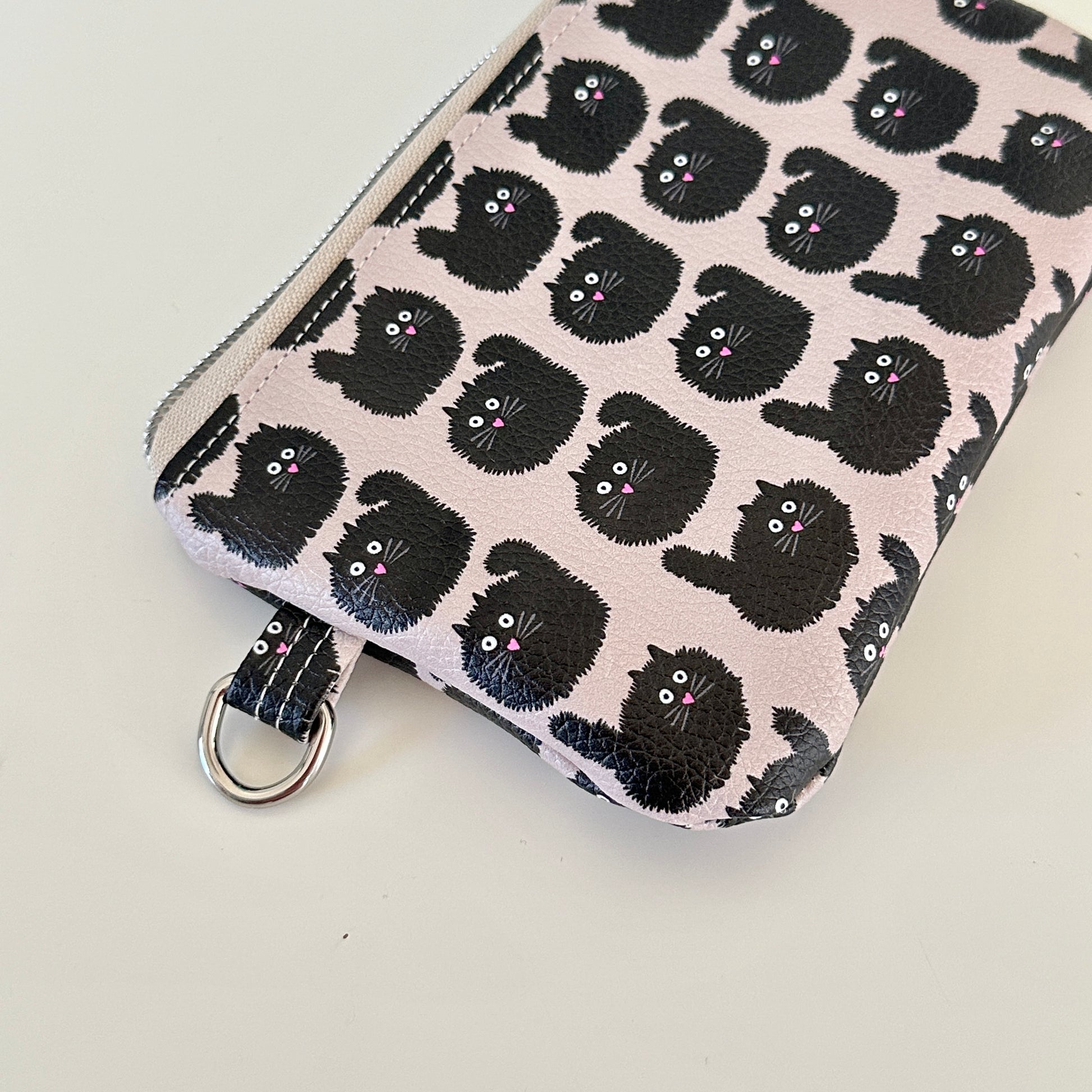 coin purse with a black cat pattern on a light background