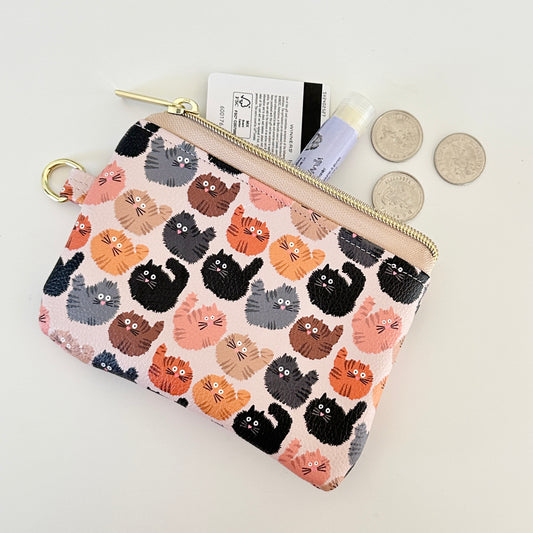coin purse with a fluffy  cat pattern on a light background