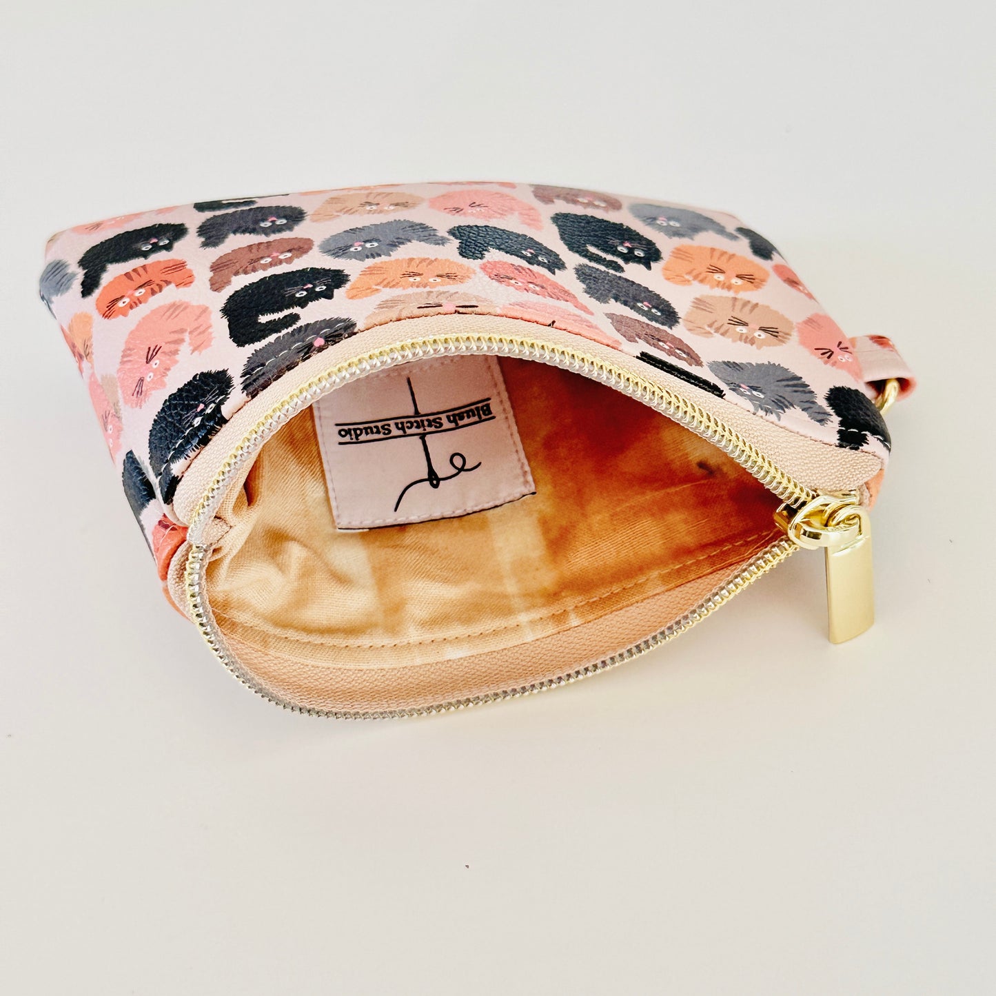 coin purse with a fluffy  cat pattern on a light background