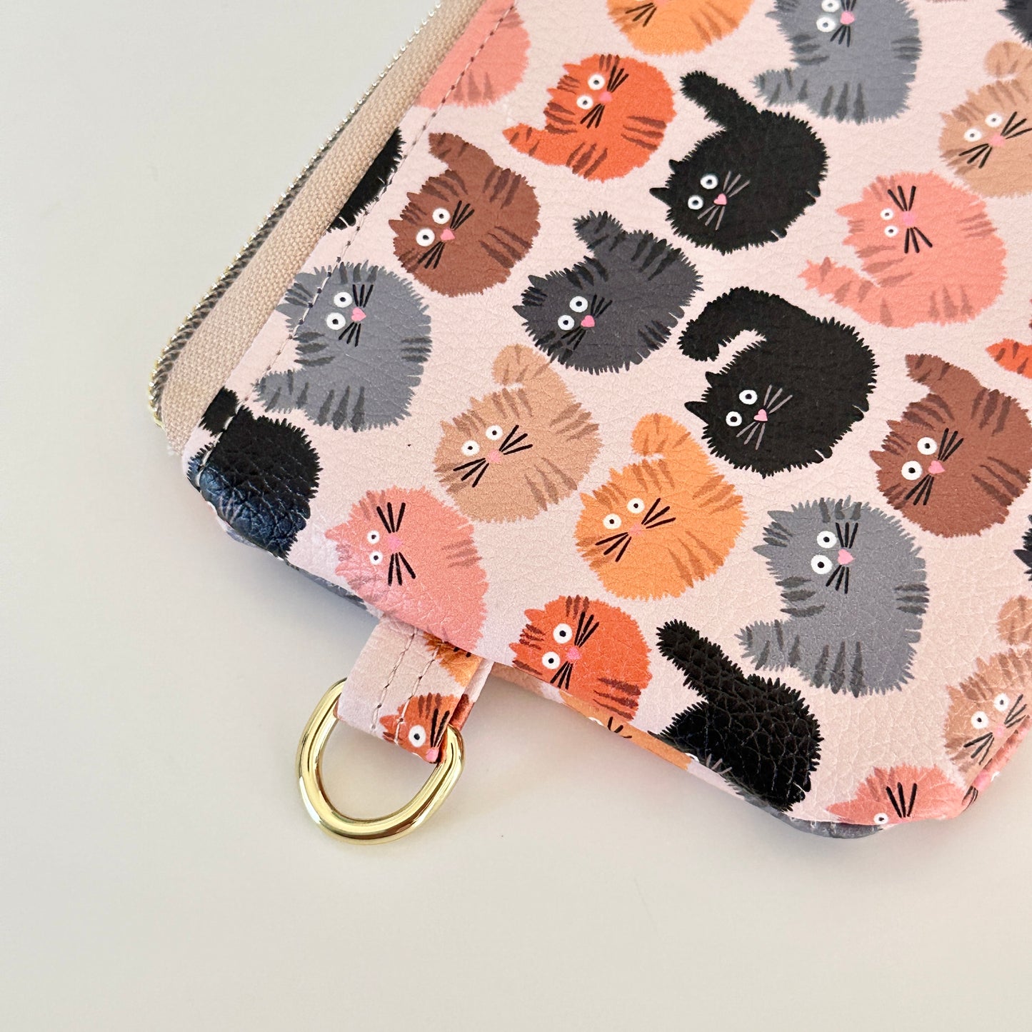 coin purse with a fluffy  cat pattern on a light background