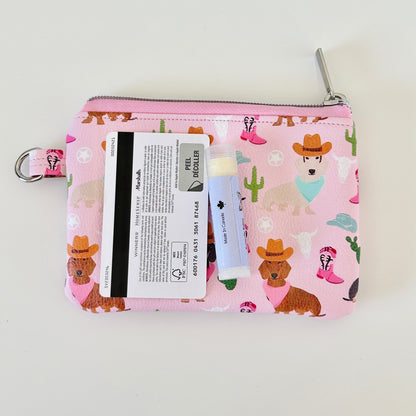 Pink coin purse with dog pattern on a white backgroundPink coin purse with dog pattern on a white background