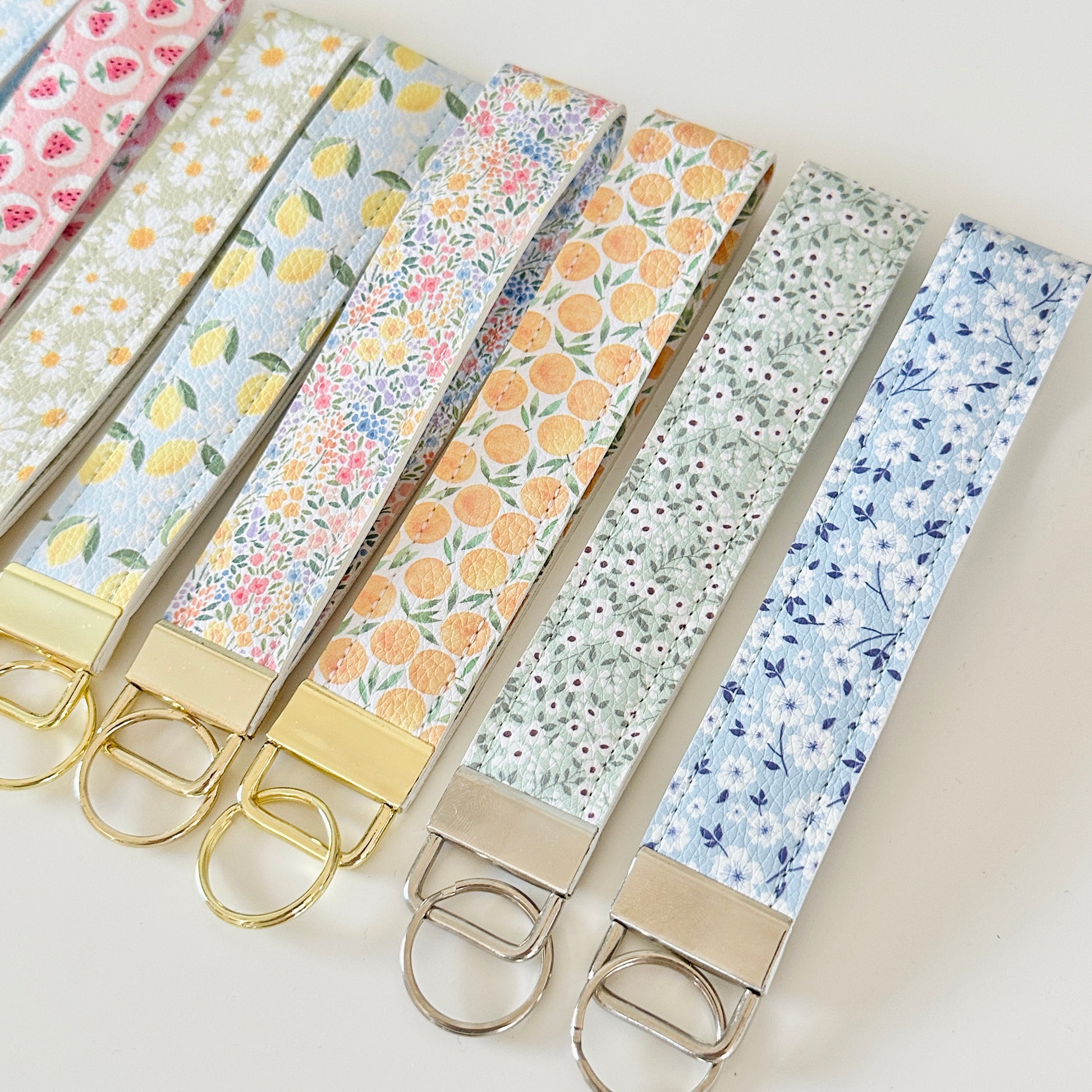 Set of floral patterned keychains on a light background