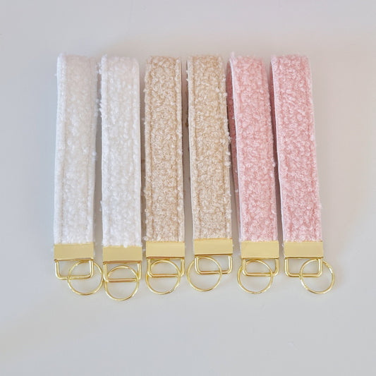 sherpa fleece , teddy key wristlets, in beige and pink with gold hardware.