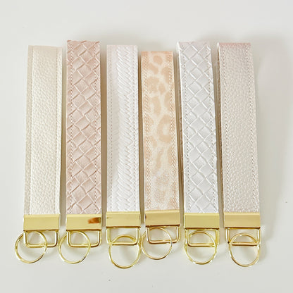 neutral white and cream key wristlet