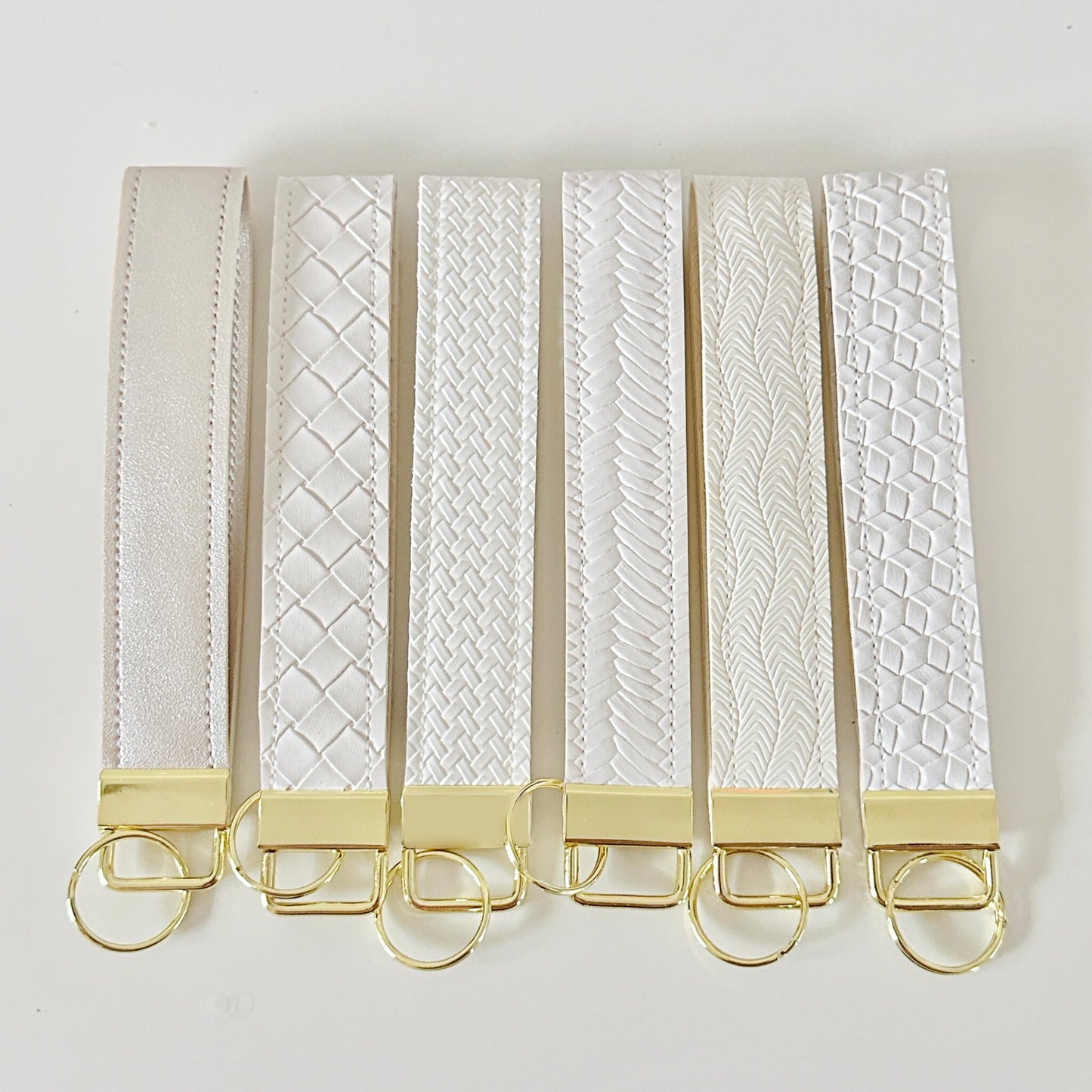 White and gold key wristlet. Neutral key strap