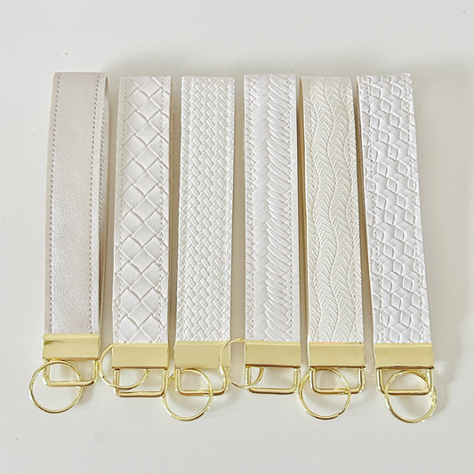 White and gold key wristlet. Neutral key strap