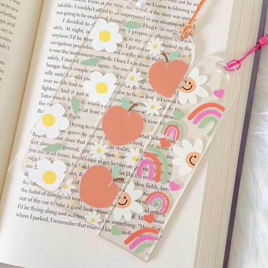 Decorative bookmark with heart designs on an open book