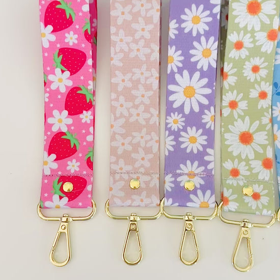 Set of six floral patterned keychains wristlet on a white background
