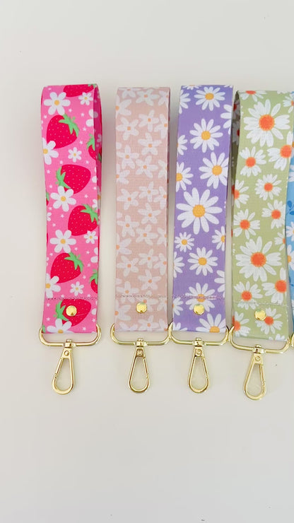 Set of six floral patterned keychains wristlet on a white background