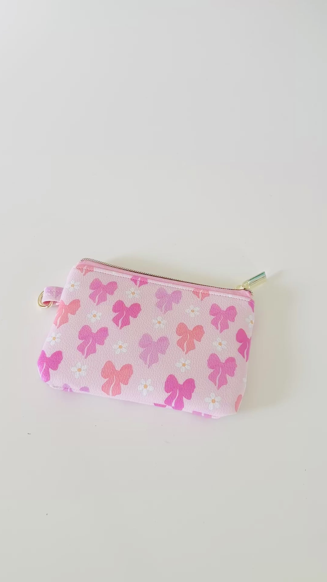 Pink coquette bow vegan leather coin purse with butterfly pattern on a white background