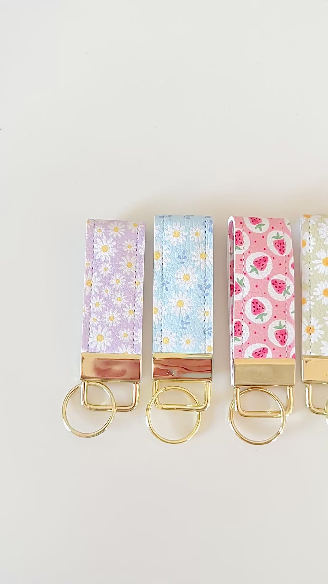 daisy floral and strawberry keychains with gold hardware