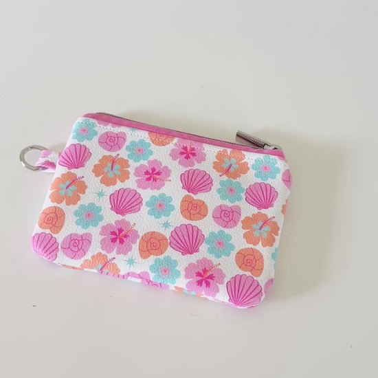 sea shell vegan leather coin purse with seashell pattern on a white background