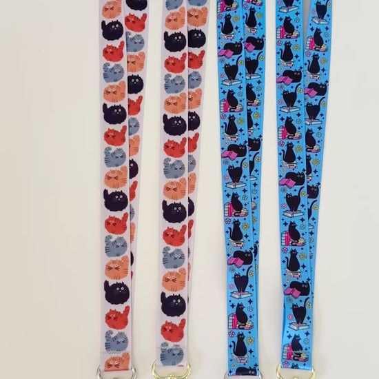 Four lanyards with cat patterns on a white background