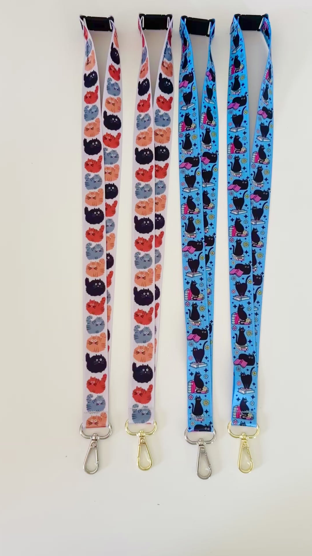 Four lanyards with cat patterns on a white background