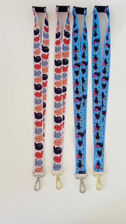 Four lanyards with cat patterns on a white background