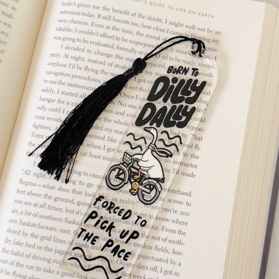 silly goose dilly dally Bookmark with tassel on an open book