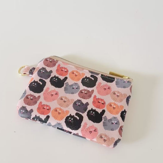 coin purse with a fluffy  cat pattern on a light background