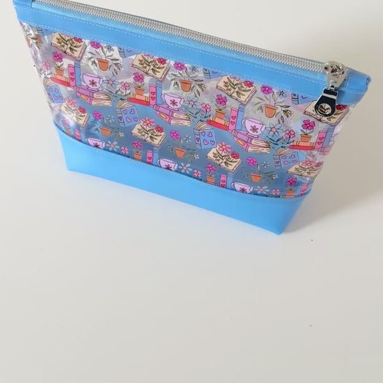 clear makeup bag with floral and book design